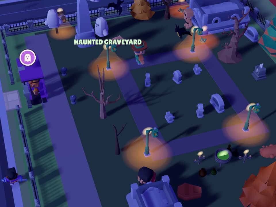 The Haunted Graveyard at night: lamps glowing over gravestones, bare trees and a crypt
