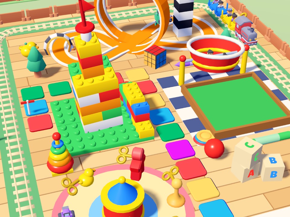 Toy Town: a tower of toy bricks, a toy train, letter blocks and a giant board-game floor